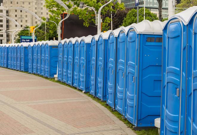 a row of portable restrooms set up for a large athletic event, allowing participants and spectators to easily take care of their needs in Conley, GA